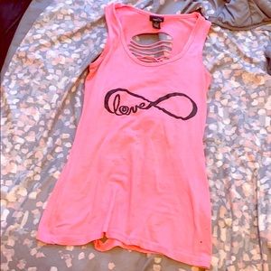a pink shirt with cursive writing “love”.